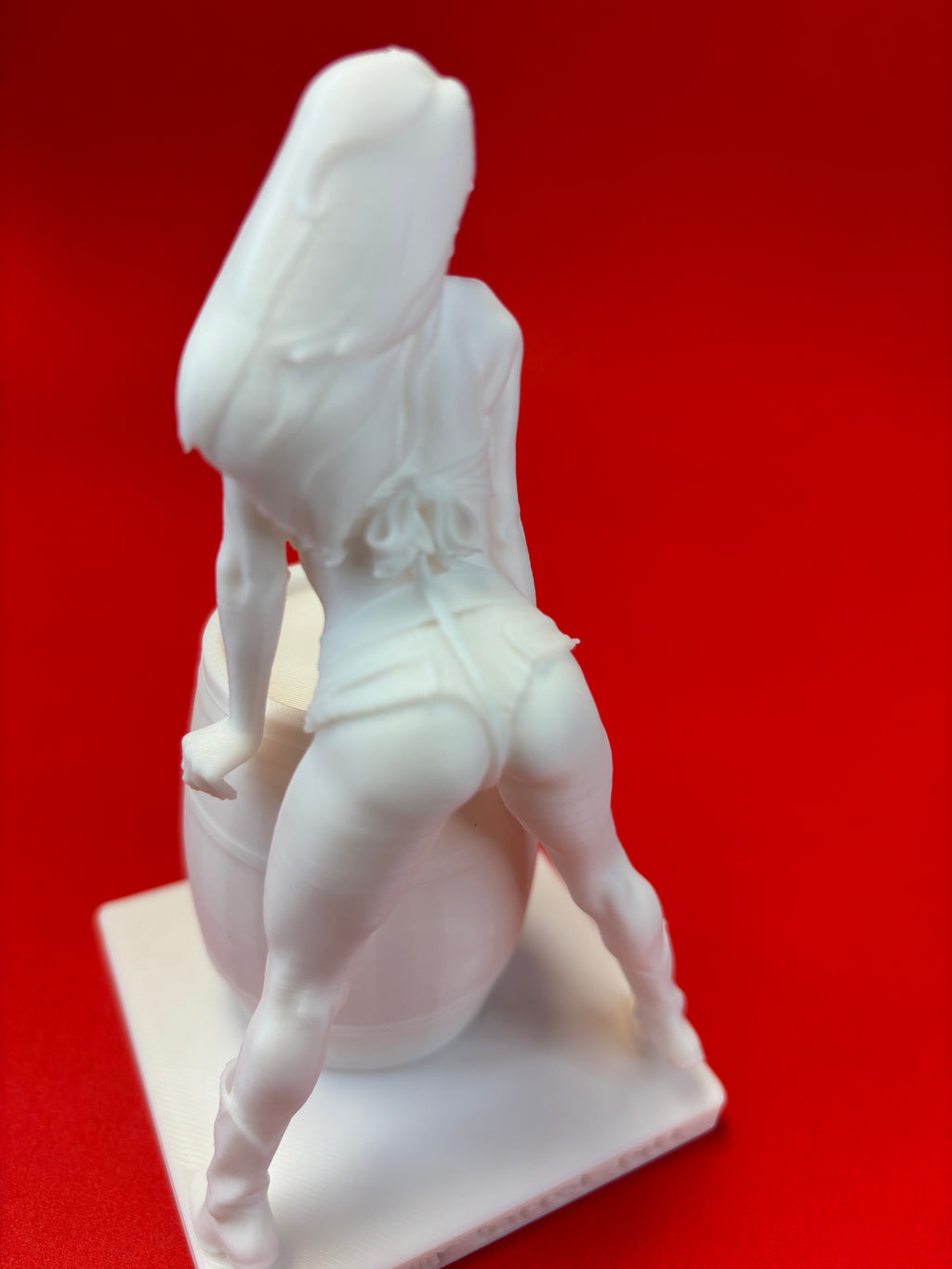 White figurine on a red background