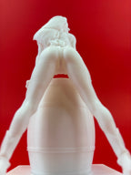 White sculpture of a figure against a red background