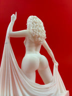 White sculpture of a woman with flowing hair on a red background