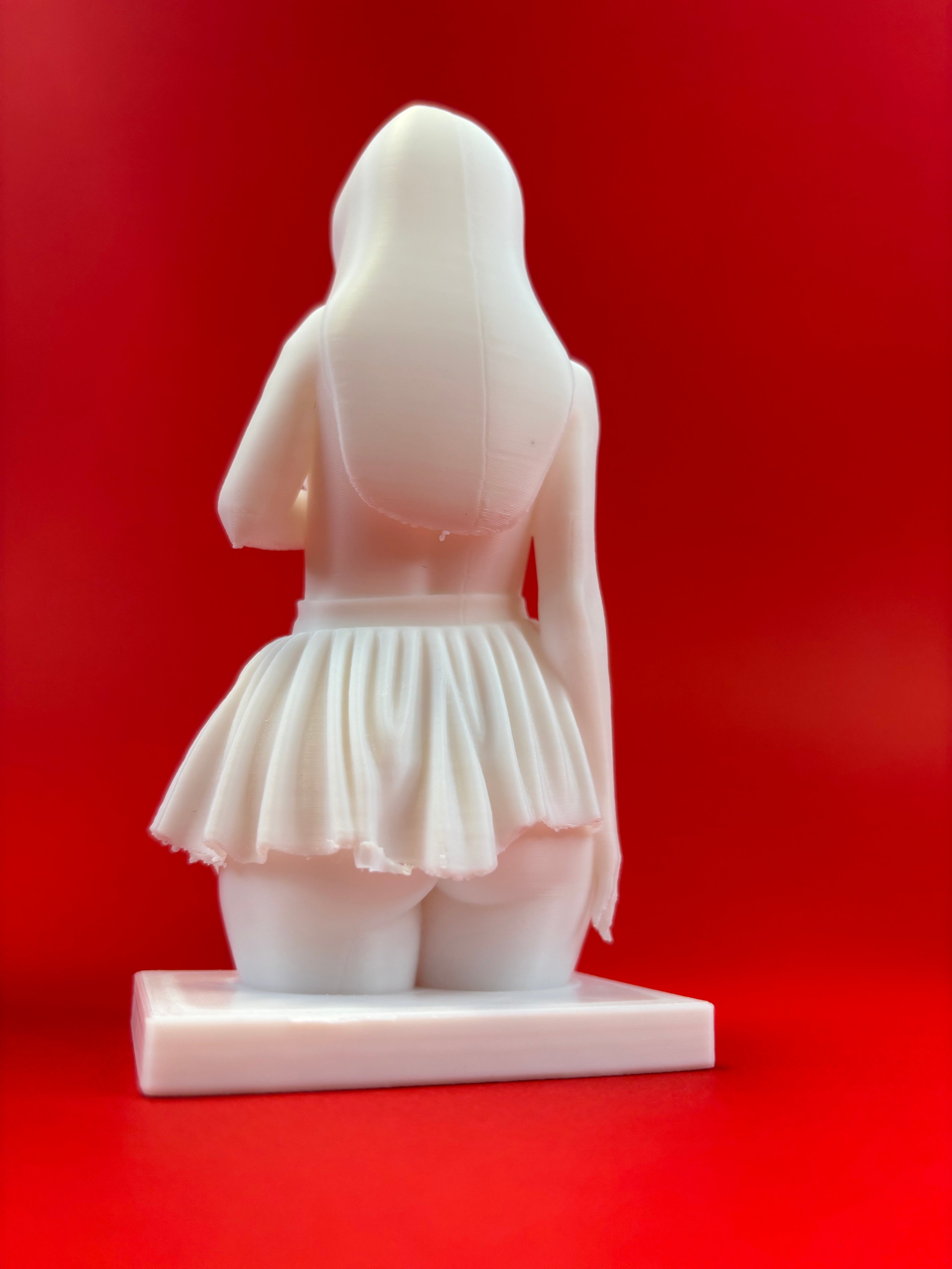 White sculpture of a draped figure on a red background