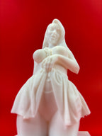 White figurine of a woman against a red background