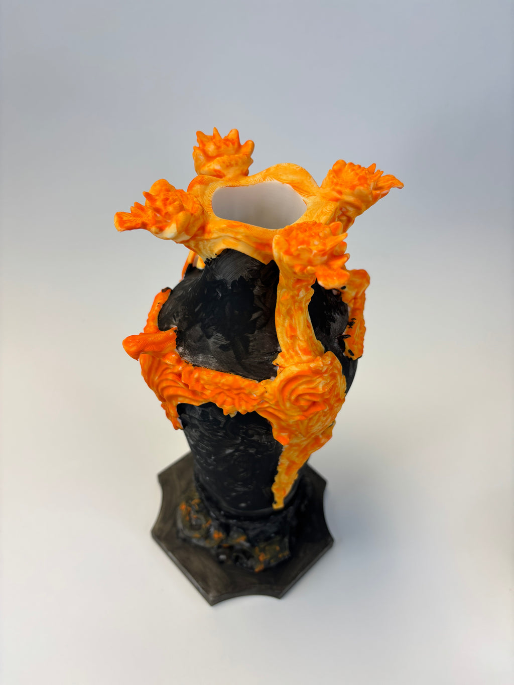 Decorative vase with black and orange flame-like design