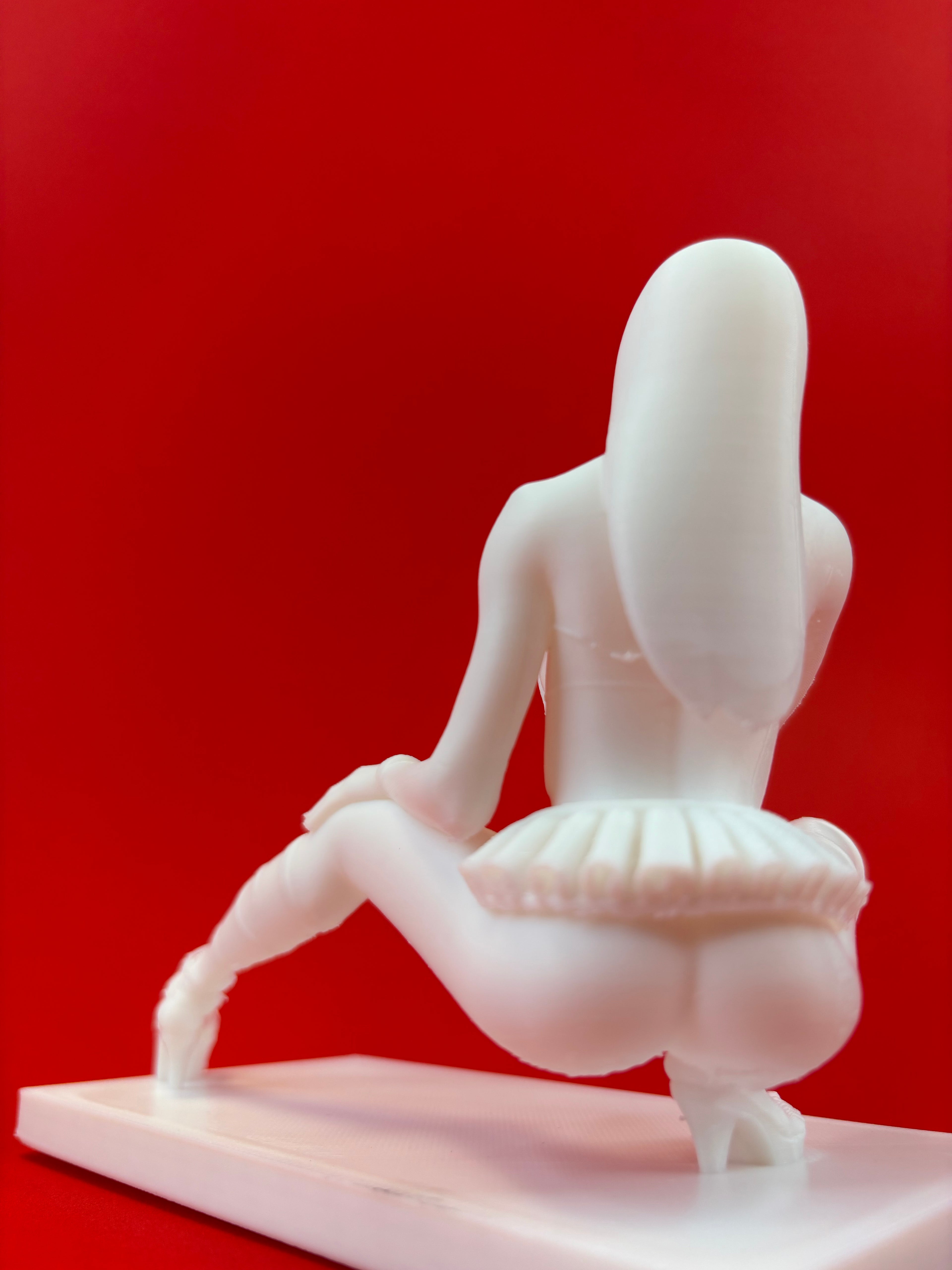 White model of a female on a red background