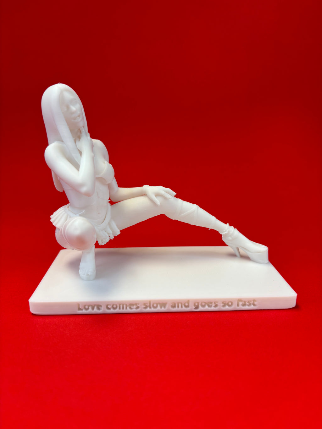 White sculpture of a person on a red background