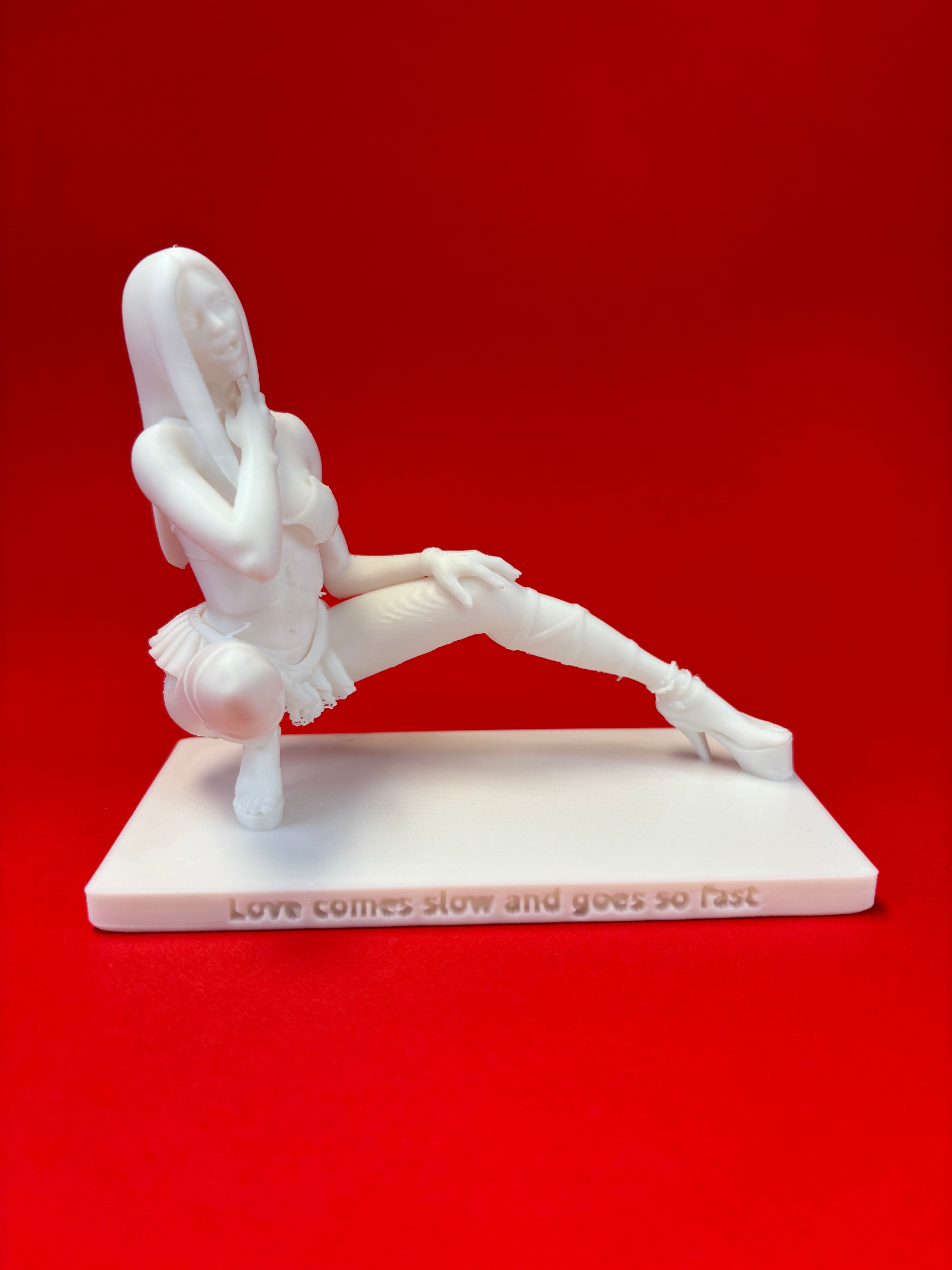 White sculpture of a person on a red background