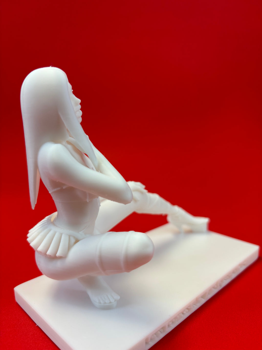model of a figure on a red background